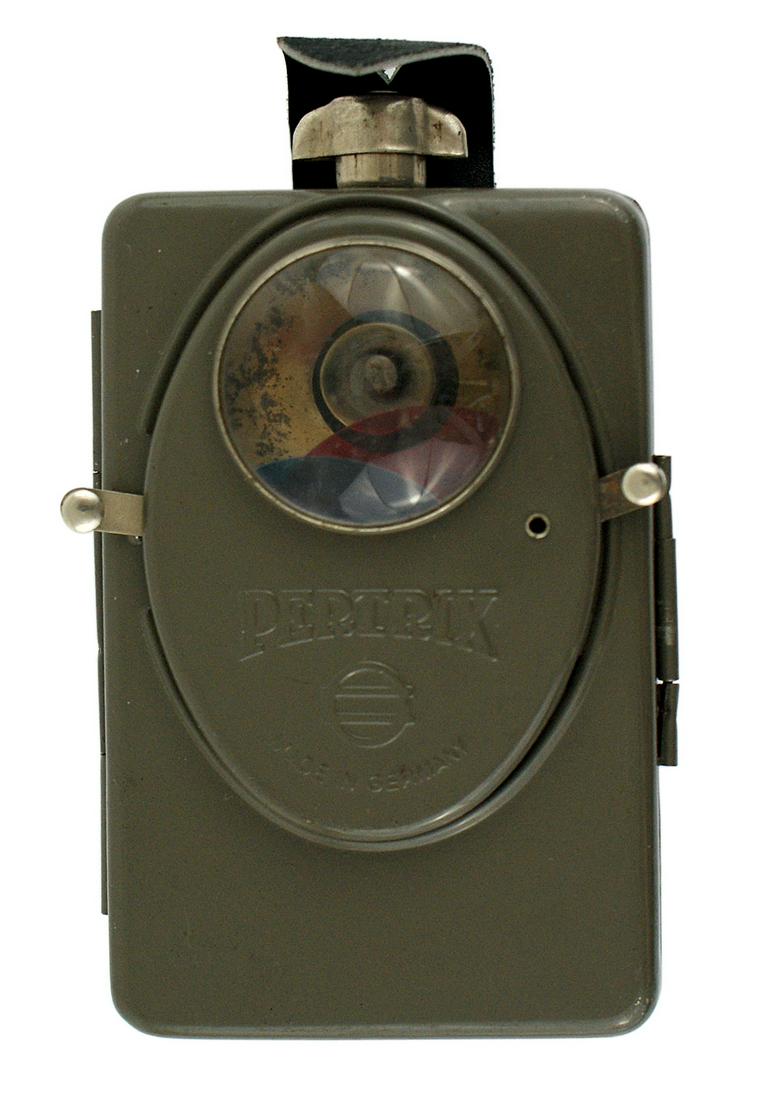 German WWII Army flashlight PERTRIX: N-009 German WWII Army flashlight. Variation type made by "PERTRIX". Oval raised area holding a convex lens and two levers which control the blue and red lens. Leather buttonhole tab. I