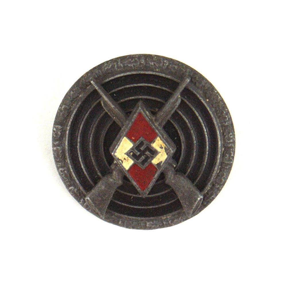 German WWII Hitler Youth Sharpshooter Badge: B-049 German WWII HJ (Hitler Youth) Sharpshooter Badge. Wartime with a painted red/white diamond with crossed rifles affixed to a black target. Outer border of oak leaves (silver finish is gone). Reve