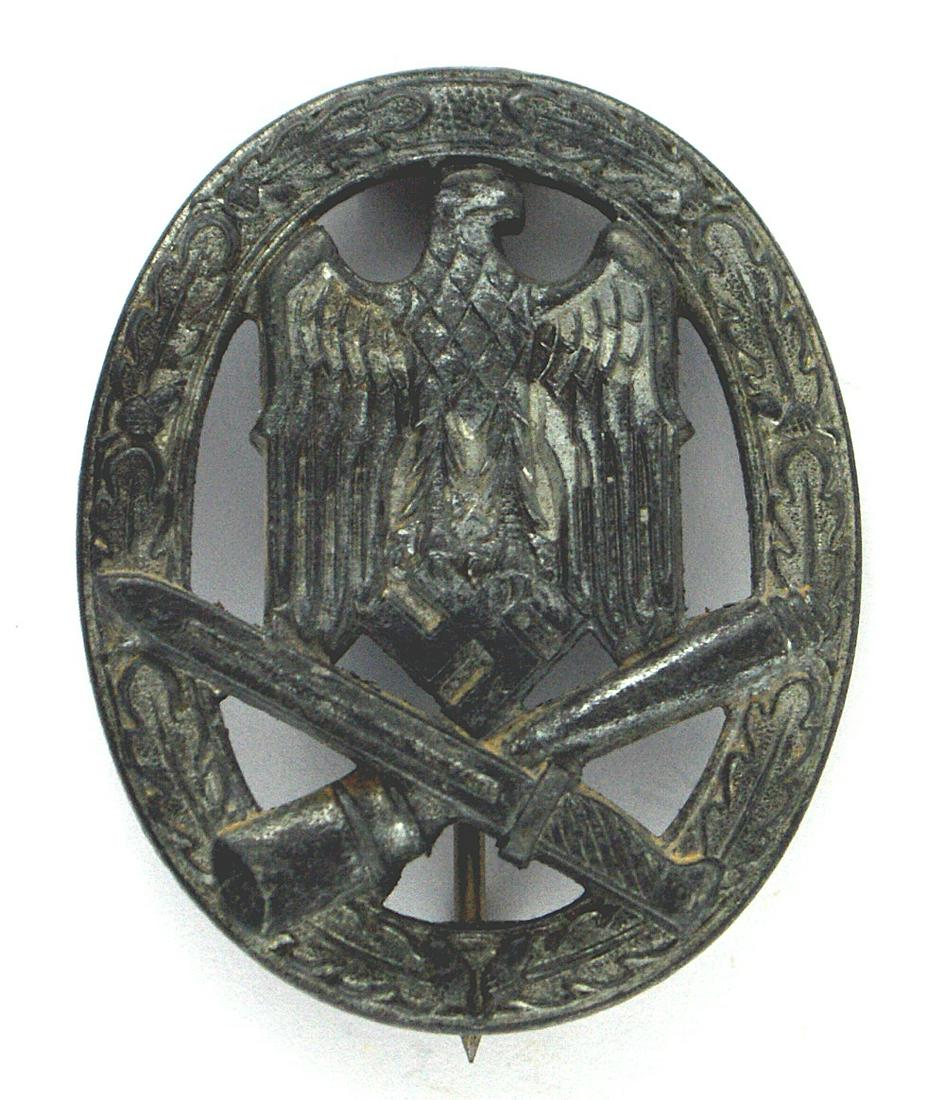 German WWII General Assault Badge: B-118 German WWII General Assault Badge. Oak leaf wreath with a cut-out large eagle/swastika/crossed bayonet/grenade. Heavy type with traces of the silver finish. Slight dished reverse. Round pin. II