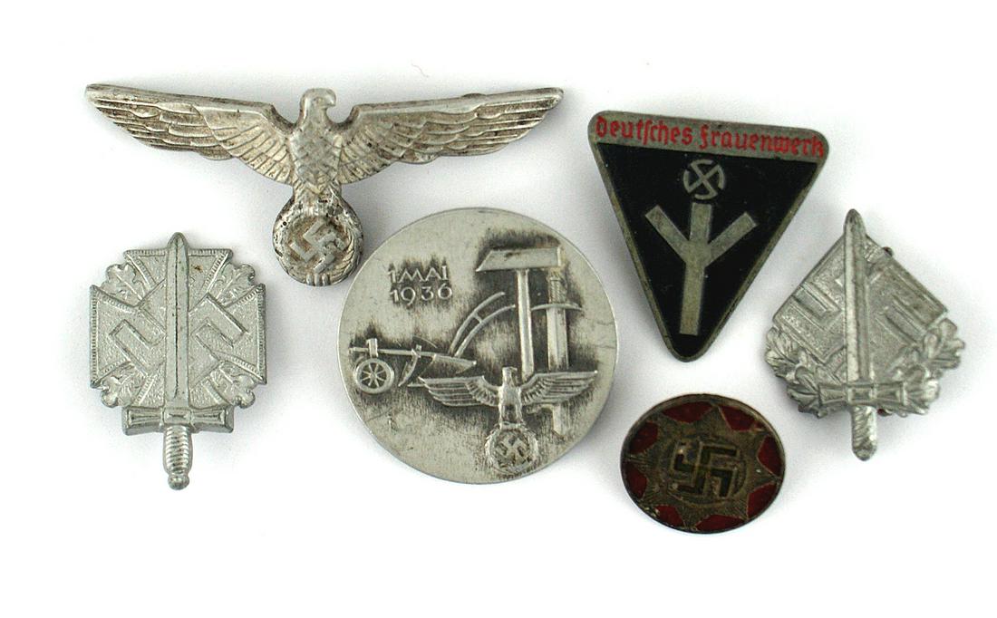 German WWII lot Army cap eagle badges: B-144 Third-Reich miscellaneous lot: (1) Army peaked cap eagle/swastika. (2) "Deutsches Frauenwerk" member's badge. Marked "RZM" and "M1/63". (3) 1936 May Day Badge. (4) Two Police Day contributor's b