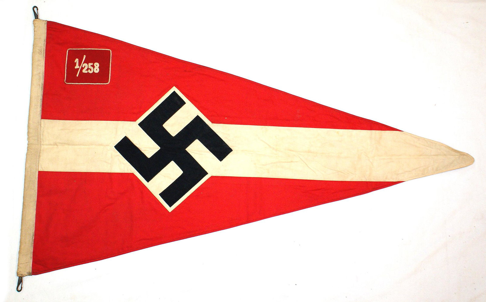 German WWII BDM Madelgruppe pennant: H-079 BDM Madelgruppe pennant. Hitler Youth format - tilted black swastika sewn to a white "diamond on white panel-on a red triangular field. White cord piped rose "patch" with white chain-stitched "1