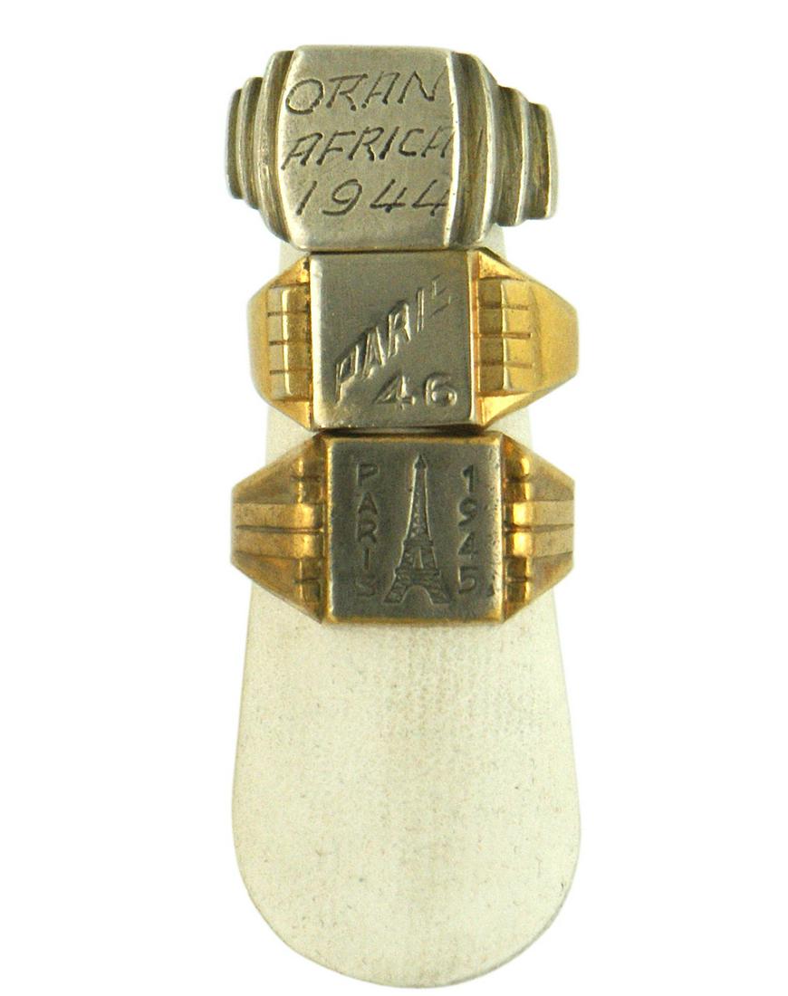 American GI WWII souvenir lot of 3 mens rings: H-161 American GI's WWII souvenir lot of 3 men's rings: (1) Four stepped sides with a flat face - engraved "ORAN N. AFRICA 1944". Probably silver. With original ring case. (2) Silver-gilt band with 6