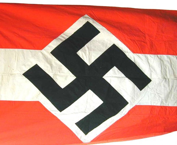 German WWII HJ Hitler Youth flag: H.J. (Hitler Youth) building banner. 90" x 60" black printed "tilted" swastika on a white diamond with an extended 20" white panel at the top and bottom – on a red field. 186" x 128". Two rope loops