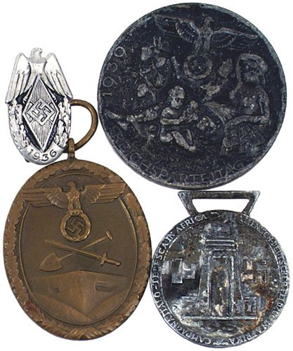 German West Wall Medal: B-66 - Lot of 4: (1) West Wall Medal - no ribbon. (2) Afrika Corps Medal (some corrosion) - no ribbon. (3) "1936 REICHSPARTEITAG" "tinnie". (4) 1936 HJ National Meet "tinnie". II.....$30.00