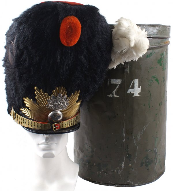 French grenadier bearskin helmet: E-6 French grenadier bearskin helmet. Excellent body with a silvered flaming grenade insignia affixed to a gilt starburst. Brass chin scales (right side small back strap is missing). Gilt star bosses.