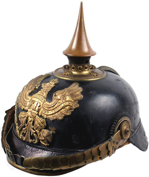 German Prussian Infantry officer helmet: E-10 Prussian Infantry officer helmet. Solid black patent leather body shows some minor surface scratches. Brass visor trim, spine, spike/base/stars and flat replaced improper chinscales. Patina on gi