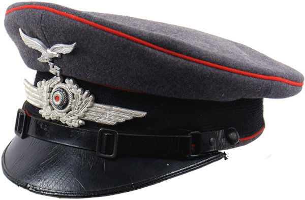 German Luftwaffe Flak peaked cap: E-125 Luftwaffe EM Flak Troops. Black band and red piping on a gray-blue body. Black leather visor (some age "spiders") and chinstrap. Silver metal eagle/swastika and winged wreath insignia. Silver em
