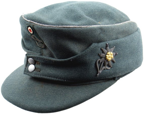 German WWII Police M1943 cap: E-144 Police officer's M1943 cap. Gray-green fine wool body with a silver wire cord piped crown. One-piece bevo embroidered insignia - rosette above an egle/swastika/wreath. Two button front. Metal "e