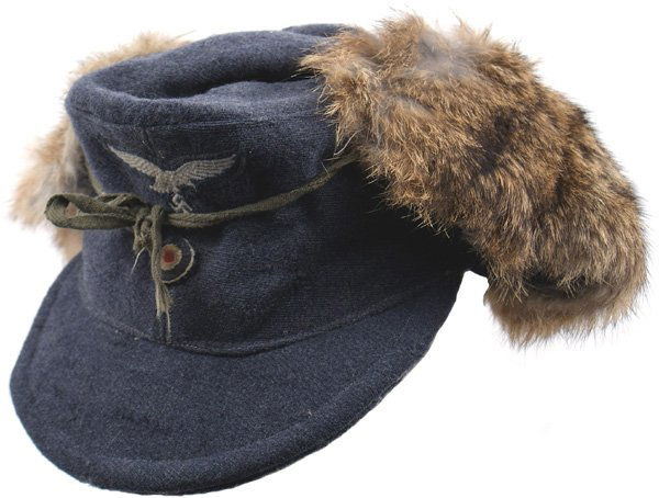 German WWII Luftwaffe M1943 cap: E-153 Luftwaffe M43 cap with rabbit fur lined side flaps. Blue-gray ribbed material with a machine sewn Luft. Eagle/swastika above a separate relief rosette. Gray lining has two "pulls". Condition II