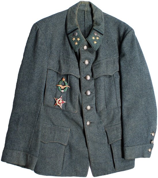 Austrian WWI Flying Corps tunic: F-7 - WWI Hauptmann (Captain) Flying Corps feld-grau tunic. Six darkened pebbled silver buttons down front and three smaller ones on each cuff. Feld-grau collar tabs with an affixed detailed silver ai