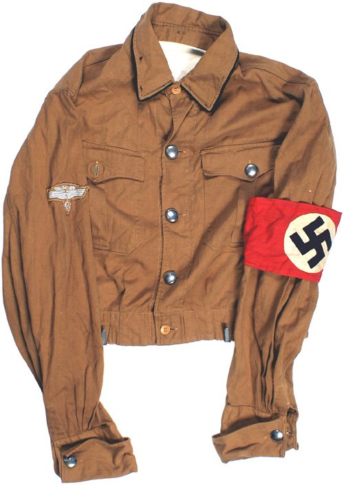 German WWII NSKK tunic: F-28 - NSKK "brown shirt". Two pocket, waist length with a total of 5 domed silver buttons and black piping around the collar. Thread remnants where collar tabs had been stitched. 3-piece NSDAP armban
