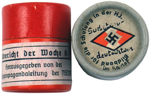 Lot 2 German WWII 35mm film: L-17 - Lot of 2 rolls of 35mm propaganda film: (1) "Sudetendeutschtum im kampf (the newly acquired Sudetenland)". In original round cardboard container with title and HJ diamond/swastika. (2) N.S.D.A.