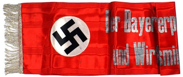 German WWII funeral wreath ribbon: H-184 - Third Reich official funeral wreath ribbon. 39" x 7 7/8" red watered silk with silver-gray embossed lettering, "The Bavarian Minister President and Economics Minister". 4 1/4" diameter white s