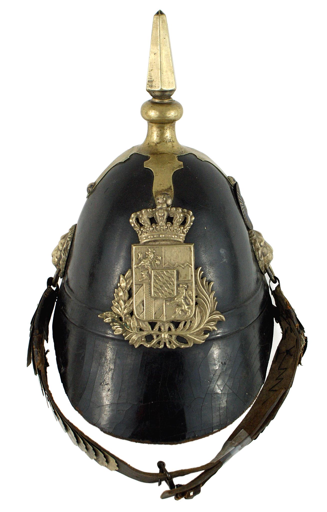 Bavarian Landwehr black leather helmet: E-005 Bavarian "Landwehr" excellent solid black leather helmet. "Melon" shaped with a 2 1/2" sloping front brim. Patina on the silver crowned state shield, "fish-scale" chinstrap with lion-head bosses