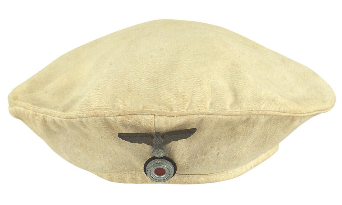 German WWII Navy white top Donald Duck cap: E-061 German WWII Navy white top for a "Donald Duck" cap. Age toned stick-pin type gilt eagle/swastika/rosette. Shows some wear. II