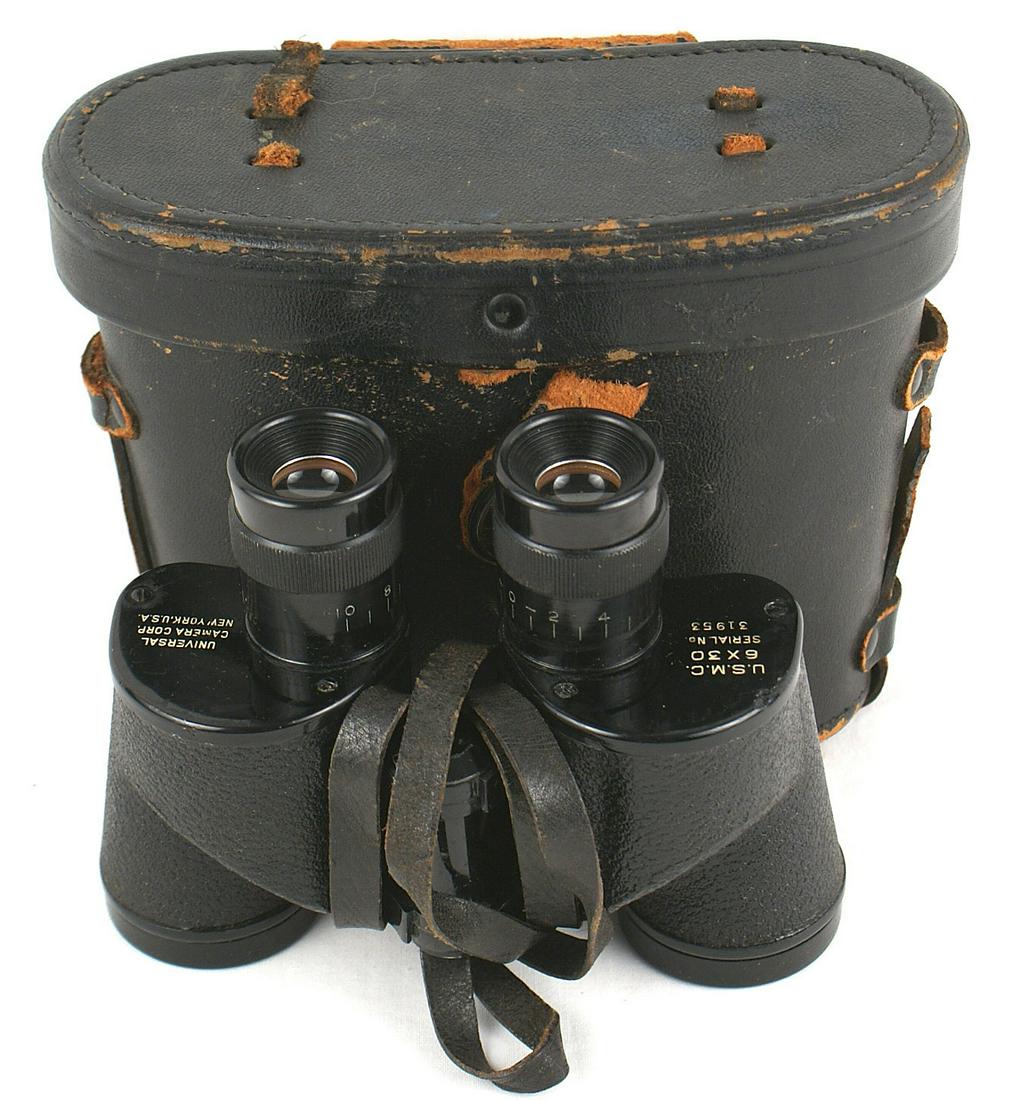 US Marine Corps WWII binoculars: N-044 US Marine Corps WWII binoculars. Marked "USMC - 6 X 30 - SERIAL NO. 31953" and "UNIVERSAL CAMERA CORP. - NEW YORK, USA." Clear lenses with leather neck strap. Hard leather case shows wear on the