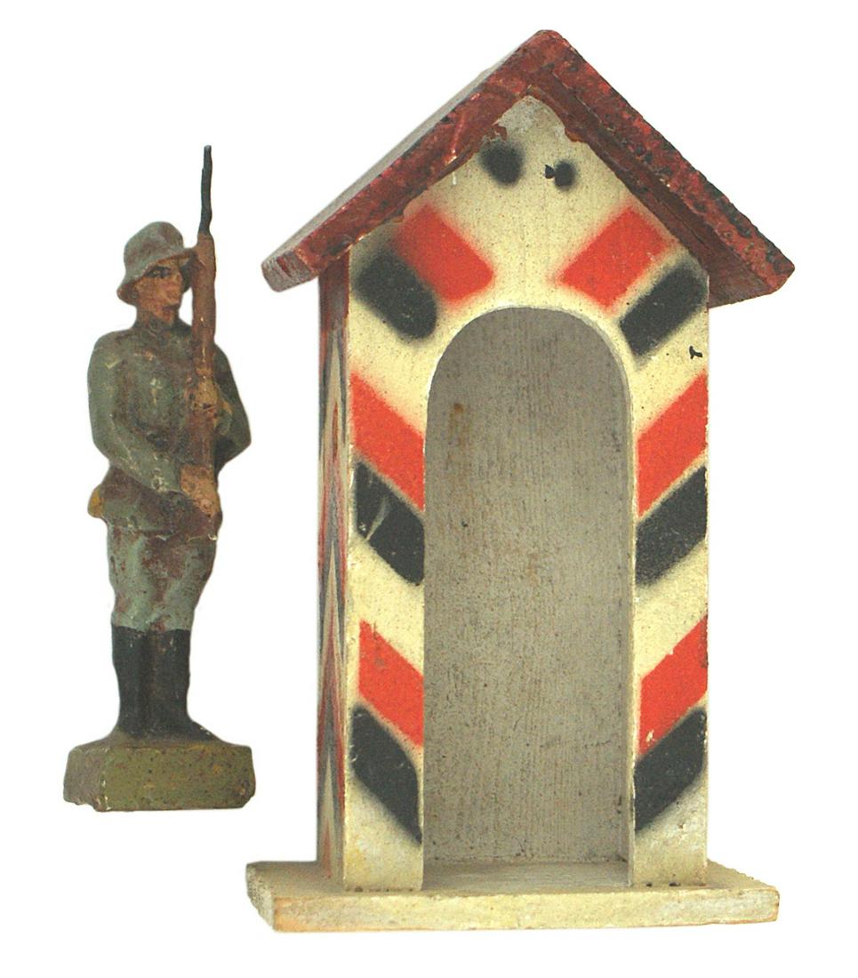 German 1930s toy soldier guard LINEOL: H-057 German 1930's toy soldier (guard) with base marked "LINEOL - GERMANY". With original 4 1/2" tall "guard shack" - Painted with red-black-white "chevrons". II