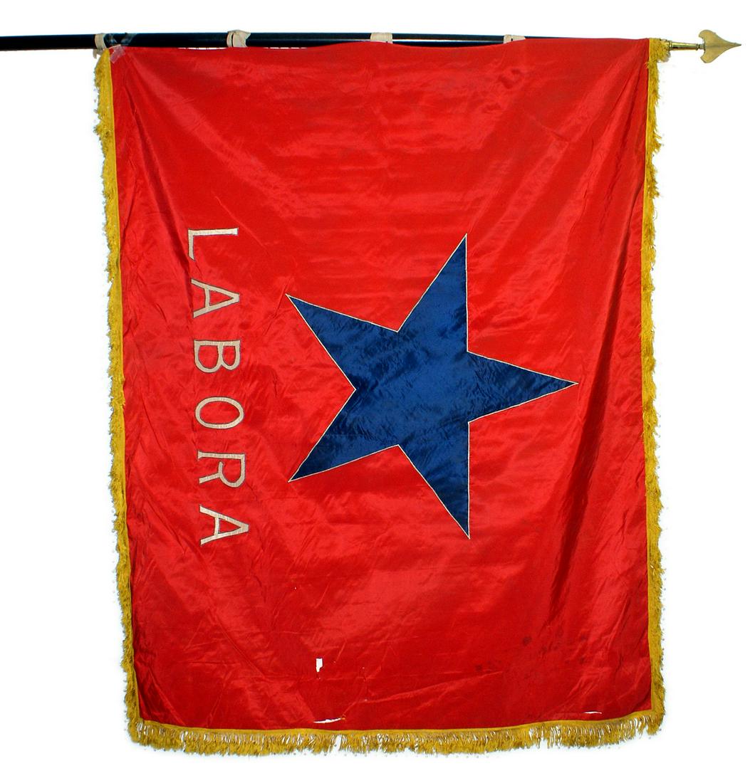 Spanish Civil War leftist union parade standard flag: H-164 Spanish Civil War leftist union parade standard. Large 29" x 29" blue 5-pointed star above white lettering "LABORA", on a red silk field. Yellow-gold fringe. 54" x 78". Some small separations ne