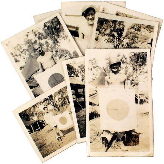 Lot of 9 U.S. WWII photographs: L-30 Lot of 9 U.S. WWII photographs. Includes a G.I. wearing cowboy boots, holding a Thompson submachine gun, and seven photos of individual G.I's holding a captured Japanese flag. II