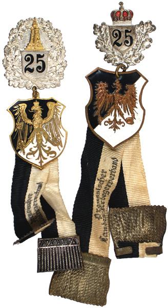 Lot of 2 Prussian War Veterans Membership badges: B-30 Lot of 2 Prussian War Veterans 25-yr. Membership badges: (1) Gold Prussian eagle on a black/white shield suspended from a silver oak leaf badge with "25" and a gold monument. Double ribbons with 