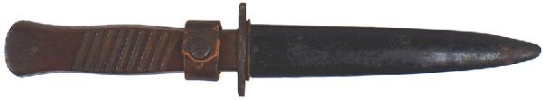German WWI trench knife: D-35 German WWI trench knife. "Coffin-shaped" serrated wood grips. Clean dagger type blade marked "GOTTLIEB HAMMESFAHR SOLINGEN FOCHE" and Waffen stamp. Black steel scabbard with an attached leather b