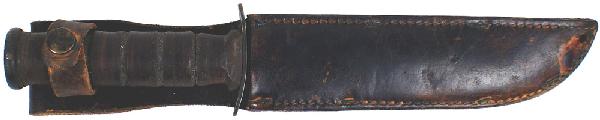 U.S. WWII Marine Corps KA-BAR combat knife: D-91 U.S. WWII Marine Corps "KA-BAR" combat knife. 1 1/4" wide, 7" parkerized blade, darkened pommel cap and crossguard – marked "USMC" and "Camillus N.Y.". Leather rings grip. Leather scabbard with