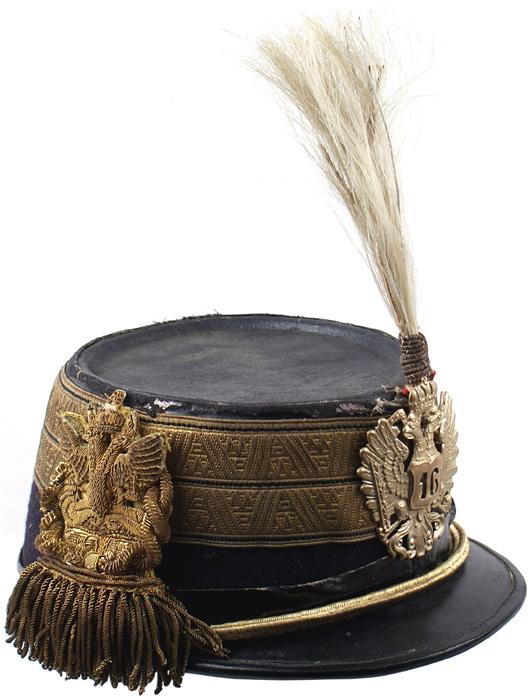 Austrian Colonel 16th Infantry Staff Officer shako: E-13 Colonel 16th Infantry Staff Officer shako. Similar to above – but with a black stripe through the center of the gold band and also on the inner borders. Subdued gold eagle with a "16" on shield