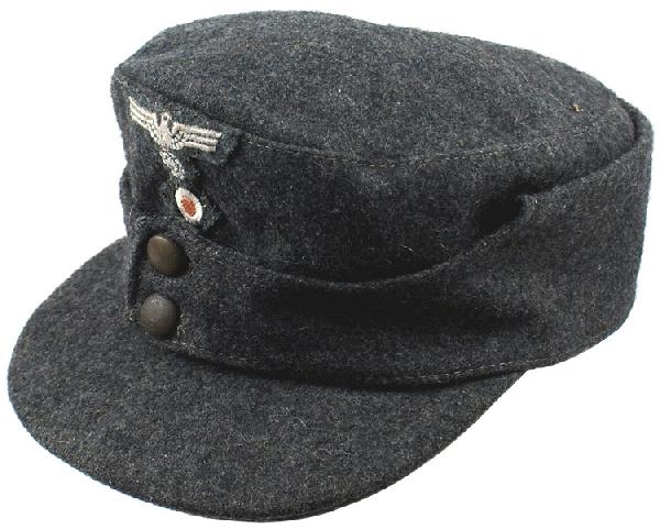 German Luftwaffe M1943 visored field cap: E-148 Army late war M1943 field cap. "Ersatz" gray-dark green material with a two-button flap. Eagle/swastika and rosette are embroidered on a similar type of "ersatz" background. Gray silk type HBT l