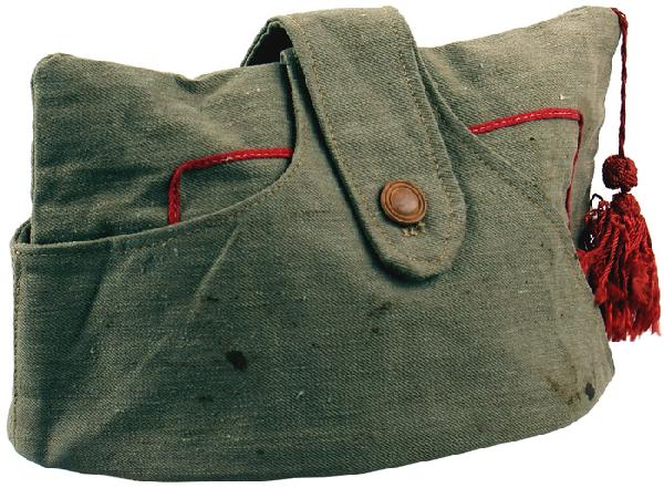 Italian WWII Fascist forage cap: E-194 Italian Fascist forage cap. Khaki with a button-down strap across top. Red piped inner border with a red tassel. Lining stamped with maker and "ITALIA…". Type of cap worn in Africa. About II