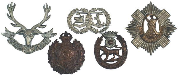 Lot of 5 WWI British cap badges: E-203 Lot of 5 WWI British cap badges: (1) Scottish Seaforth Highlanders. White metal. Reverse: three eyelets for cotter pins (missing). (2) "THE ROYAL SCOTS – 1st Foot. Brass and white metal. Cotte