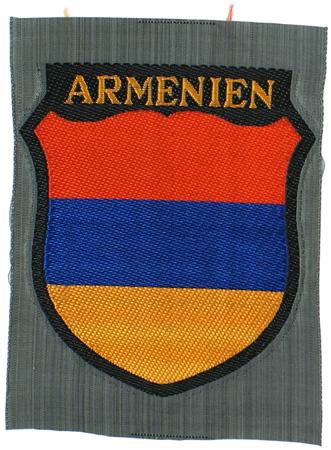 German WWII ARMENIEN sleeve shield: H-64 "ARMENIEN" volunteer sleeve shield. Red/blue/gold panels with gold lettering. Bevo embroidered on feld-grau "polished" cotton. I