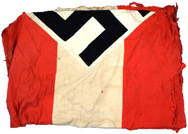 German WWII HJ Hitler Youth flag: H-102 HJ (Hitler Youth) banner. 3 1/2" wide black ribbon swastika sewn on a white "tilted" white panel – sewn on a red background with a wide white panel stripe. Shows wear and ends are tattered. II