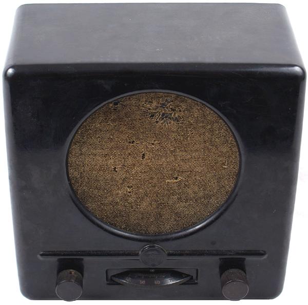 German WWII Volks radio: H-129 "Volks" radio. Bakelite body, station selector and dials. Embossed eagle and swastika. Original cloth covered speaker. Reverse is marked "Deutscher Kleinempfanger 1938". Cord has been cut. 9 1/2