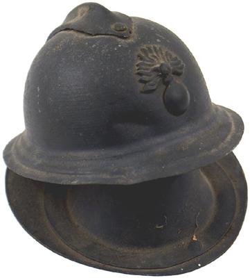 French WWI helmet ink well: H-189 French WWI helmet ink well. Adrian type – with a comb and flaming grenade insignia on front. Hinged, with the inside base shaped to hold a glass container (missing). II