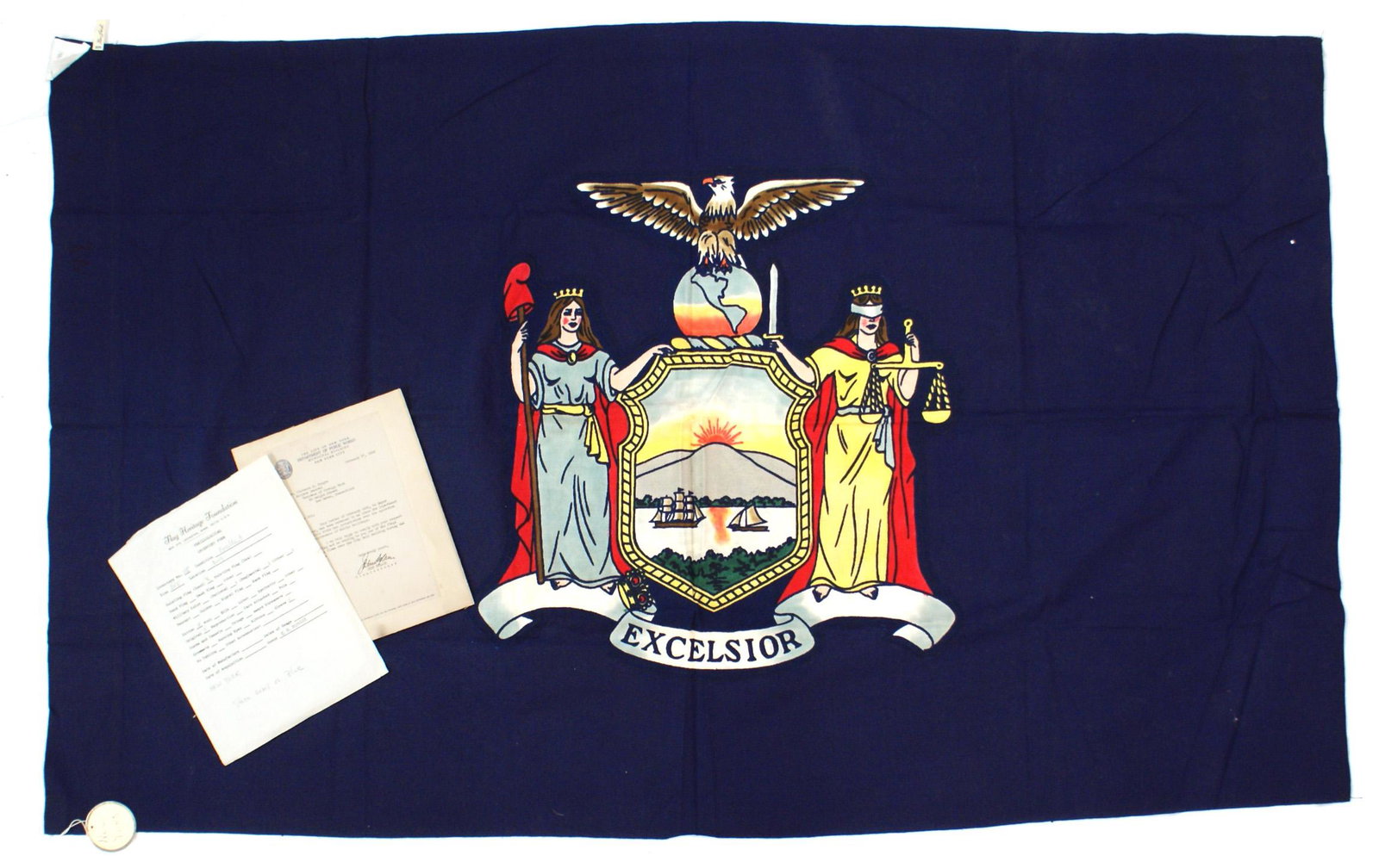 US State flag of New York: K-060 State flag of New York. Blue field with coat-of-arms in vibrant colors. Eagle on globe above shield flanked by classic figures representing Liberty and Justice. With motto "EXCELSIOR". Wide 3" p