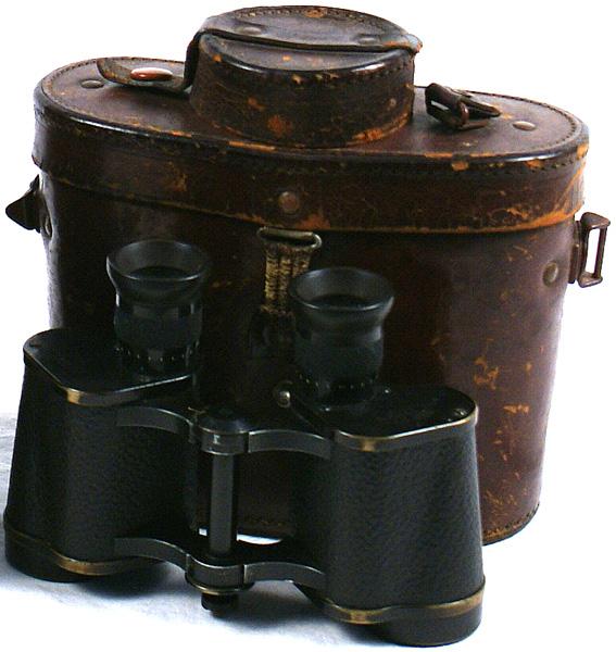 German WWII Military binoculars: N-18 Military binoculars (WWII). Marked "CARL ZEISS - JENA" - with original brown leather case - with a pair of lens covers and "pill box" cover for holding a compass (missing). II-