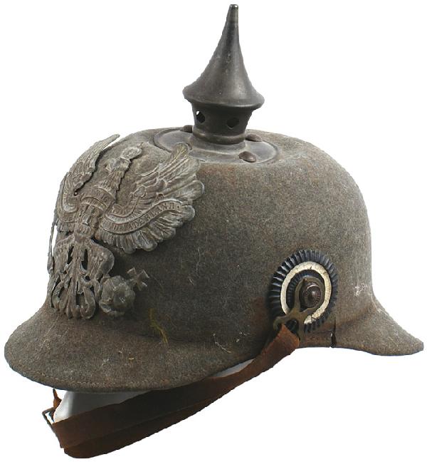 German Prussian EM felt pickelhaube helmet: E-22 Prussian EM “ersatz” felt pickelhaube. Solid O.D. body with three small “splits” on the sides of the visor. Gray Prussian eagle frontplate and spike/base shows some wear. Original brown c