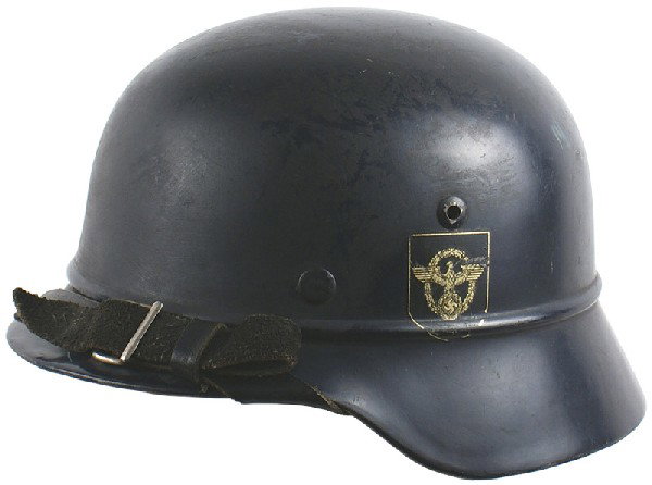 German WWII Police M1935 helmet: E-41 Police M1935 with a “bead” around base of crown. Dark blue finish with two decals: Police eagle/swastika/wreath and a swastika shield. Tan leather drawstring liner is named to “Wagner”. B