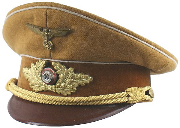 German WWII NSDAP Political peaked cap: E-128 N.S.D.A.P. Kreis Level Political Leader. White piped golden-brown crown and brown velvet band. Enameled swastika rosette within a gilt metal oak leaf wreath. Age-toned gilt long-winged eagle/swa