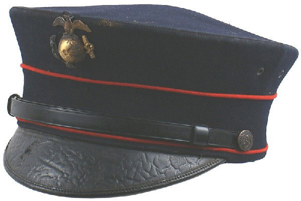 U.S. Marine Corps M1912 EM peaked cap: E-178 Marine Corps M1912 EM peaked cap. Blue wool body with two rows of red piping. Brass EGA insignia and eagle/anchor buttons. Replaced black vinyl chinstrap. Some age crackling on black leather vis