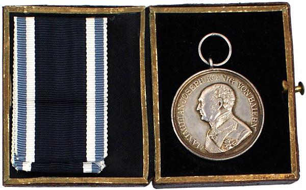 German Bavarian Military Bravery Medal Silver: B-16 Bavarian Military Bravery Medal – Silver. Bust of monarch and “MAXIMILIAN JOSEPH VON BAIERN”. Reverse: crowned lion with sword and Bavarian shield – with “DER TAPFERKEIT”. With origin