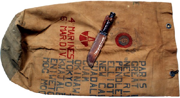 U.S. Marine WWII decorated duffle bag knife: H-178 Marine WWII art decorated duffle bag. Large EGA emblem with a red and blue 6th USMC Division insignia, a large “A” and “4th MARINES 6 MAR. DIV.”. Also nicely lettered places where owner 