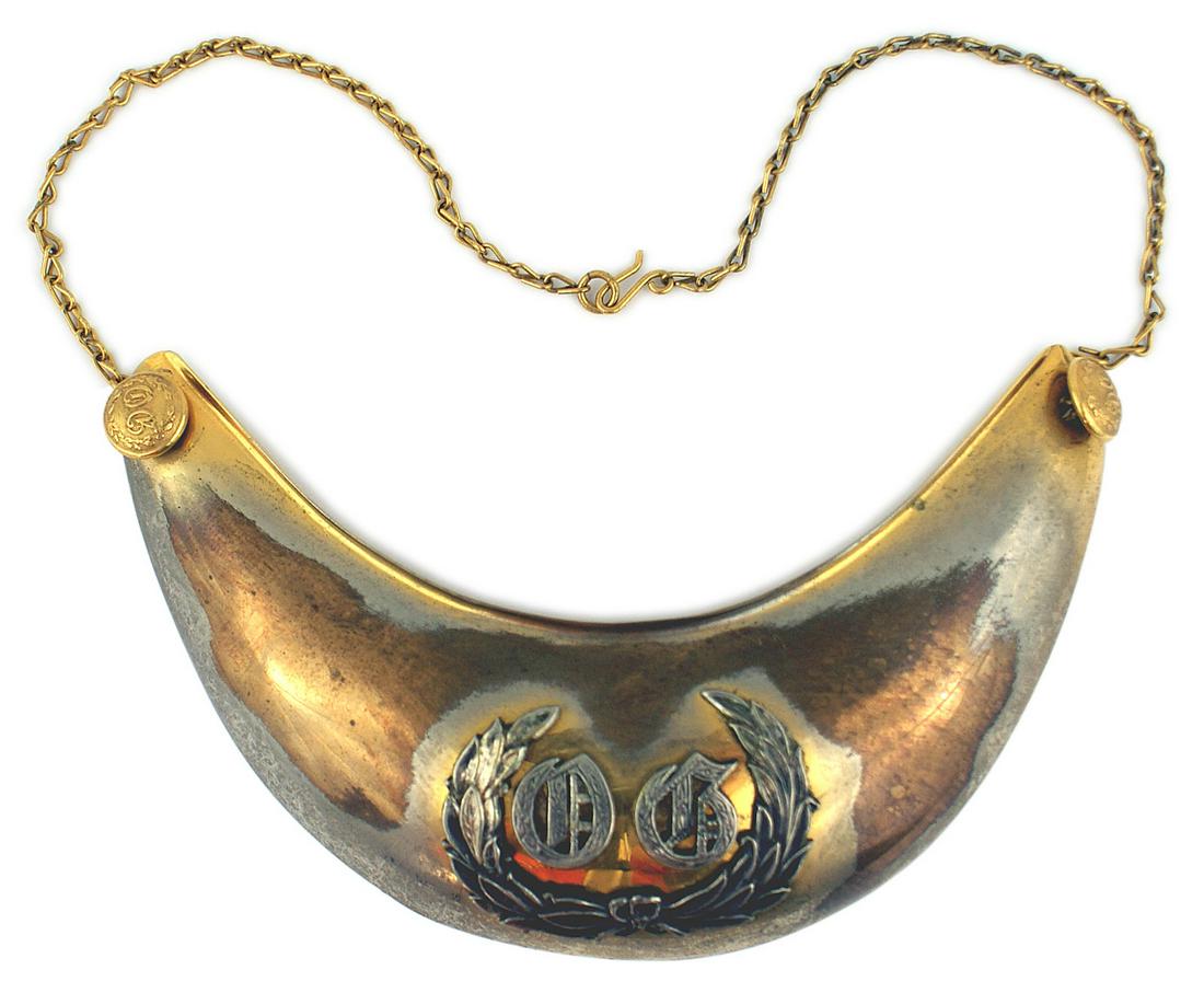 American Old Guard gorget Circa 1890-1910: K-028 American "Old Guard" gorget. Convex crescent shape with an applied relief silver oak leaf/laurel wreath - holding silver Old English style letters "OG". 60% of the original gilt finish remains.