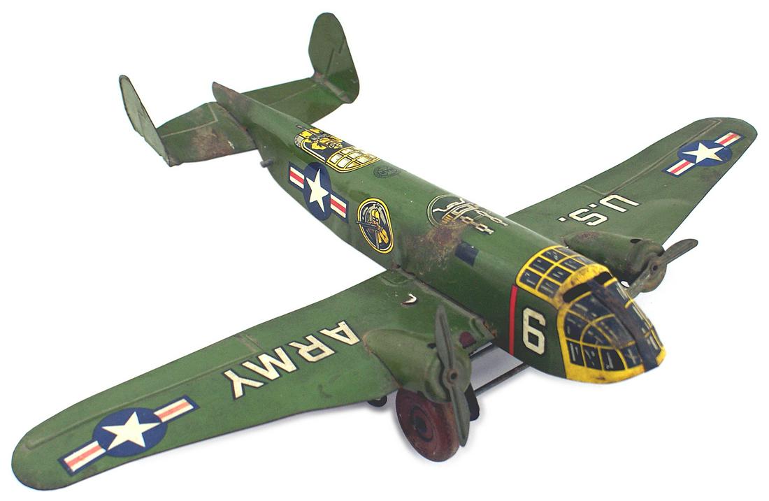 American WWII toy B-25 Liberator aircraft MAR toy: G-022 American WWII toy B 25 "Liberator" aircraft. All metal two - engine bomber. Original green body with Lithographed nose windows, side and tail gunners and US Army insignia. Several small patches 