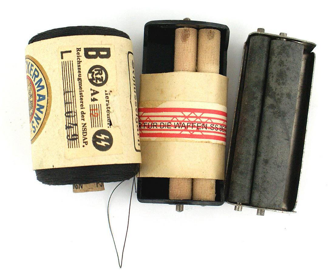 German WWII SS lot thread cigarette roller: F-033 German WWII SS lot: (1) 1000 meter spool of black thread. Maker's label "Ackermann's" and "RZM - SS" label. (2) Field issued cigarette roller. Wrapper has an eagle/swastika and "ONLY FOR THE WAF