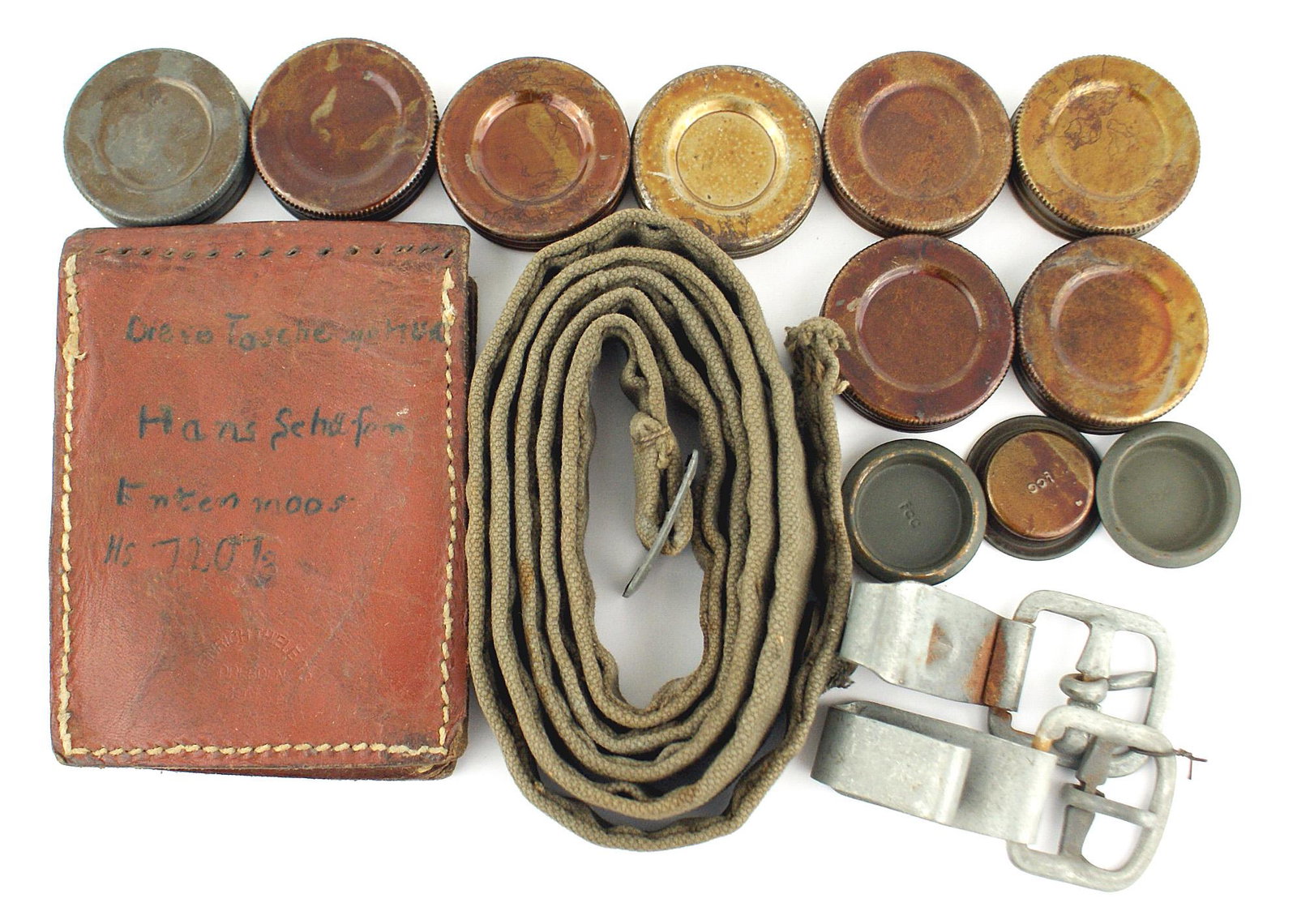 German WWII equipment accessories: N-014 German WWII equipment accessories: (1) Gas mask canister shoulder strap, cardboard form for the filter can and 11 caps for the filter. (2) 4 1/2" x 3 3/8" leather case - shaped like a map case. 