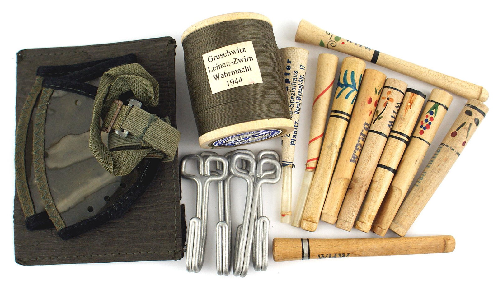 German WWII lot Army goggles thread etc: N-016 Miscellaneous Third-Reich lot: (1) Army pocket folding goggles with paper envelope. (2) Lot of 4 Army EM aluminum tunic belt hooks. (3) Spool of uniform thread - with Army label. (4) Ten unused 