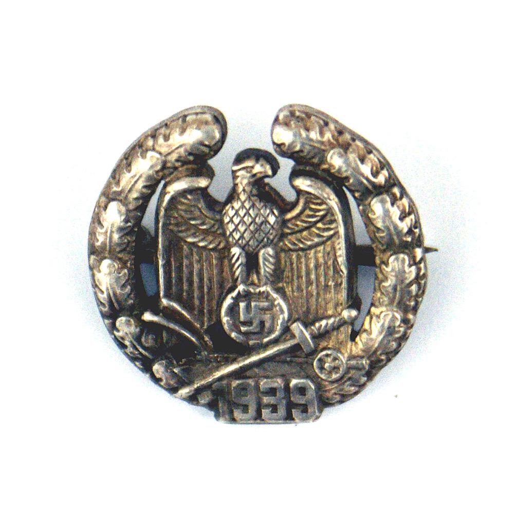 German WWII miniature Wartheland Gau Badge: B-012 German Third-Reich miniature Wartheland Gau Badge. Silver construction with a horizontal pin. Worn on the lapel. II