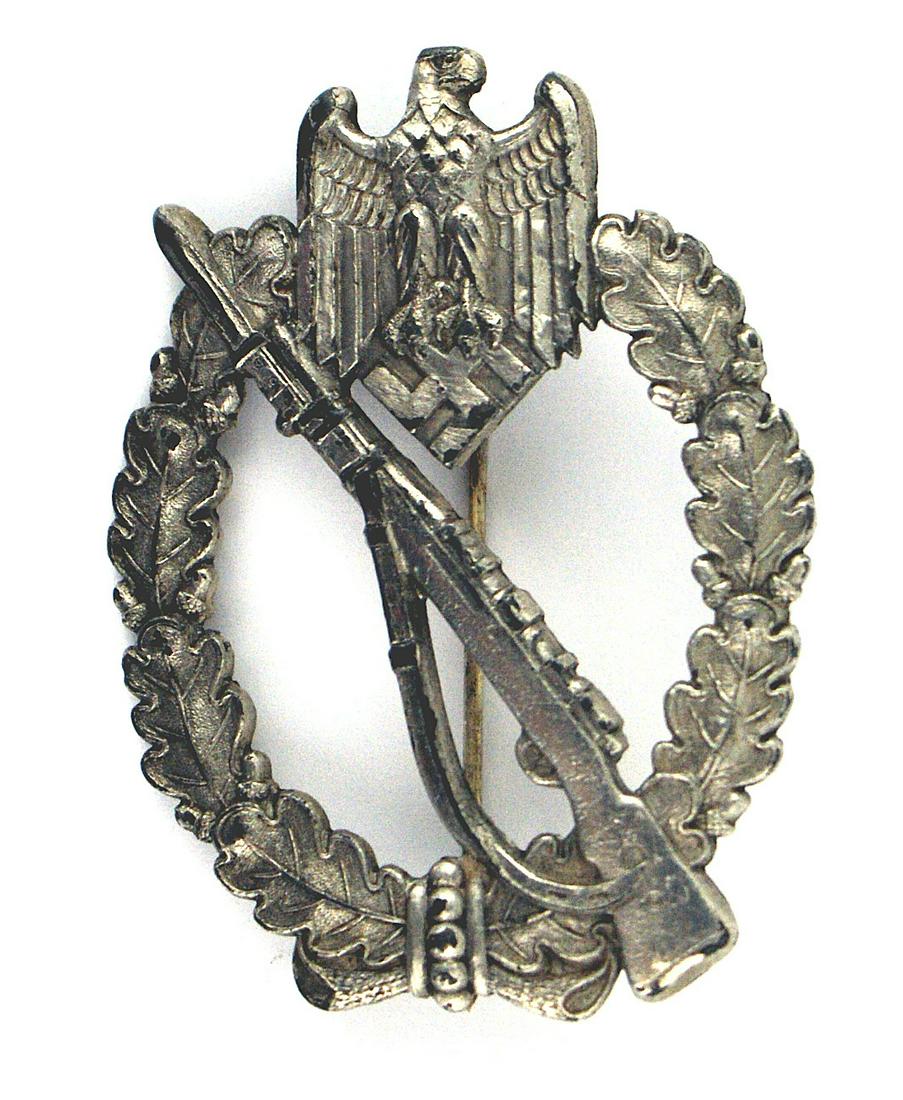 German WWII Infantry Assault Badge: B-053 Infantry Assault Badge - Silver. Rifle with fixed bayonet on an open wreath and eagle/swastika at the top. Slightly convex. Most of the original silver finish remains. II