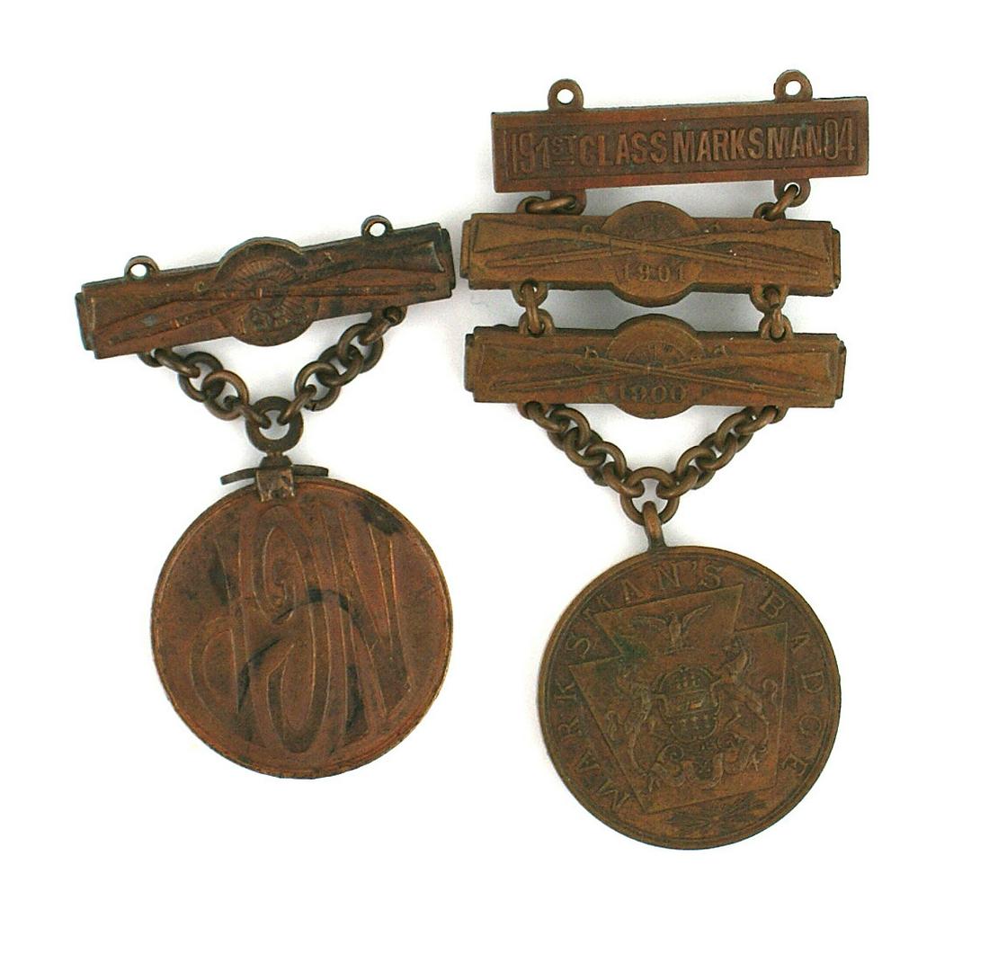 Two Pennsylvania National Guard shooting awards: B-222 Lot of 2 Pennsylvania National Guard bronze shooting awards: (1) Obverse - state coat-of-arms, reverse "NGP". Chain suspended from a pin-back bar with crossed rifles and "1888". (Medal mounted u
